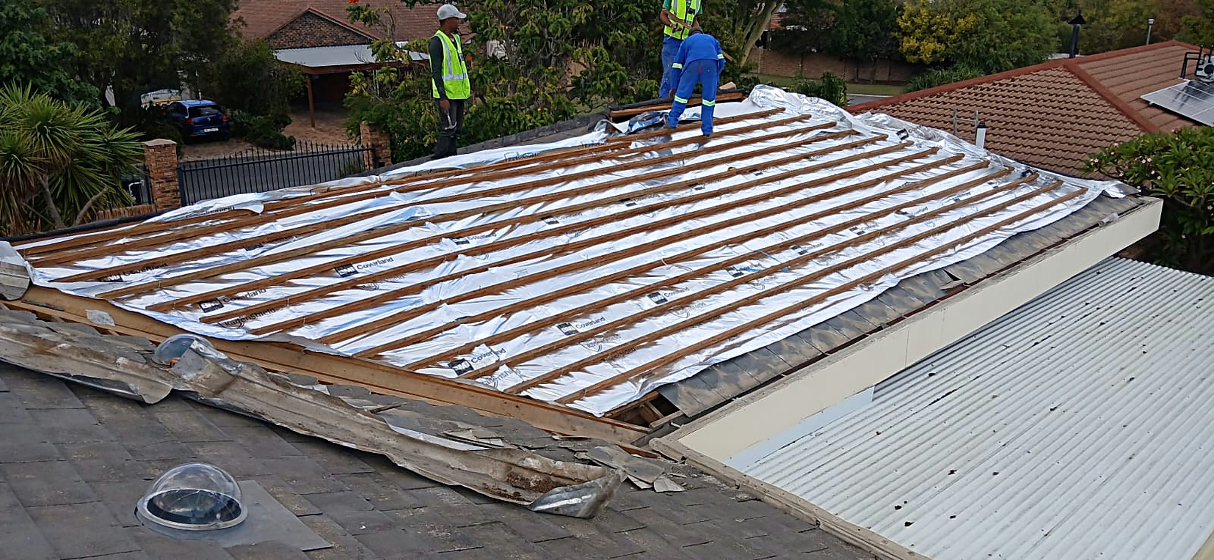 Opened-up roof being re-covered with new underlay and battens by the Neil Ambrose team