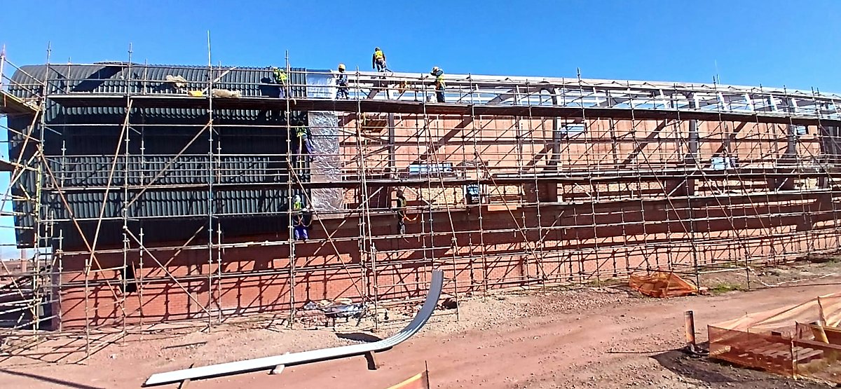 Scaffolded building with the team working along the roofline